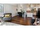 Living room view flowing into a dining area and kitchen with white cabinetry and black appliances at 13472 W Dakota Ave, Lakewood, CO 80228