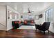 Bright living room with hardwood floors, modern ceiling fan, and two large windows for natural light at 13472 W Dakota Ave, Lakewood, CO 80228