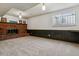 Spacious living room featuring a brick fireplace and large window at 13472 W Dakota Ave, Lakewood, CO 80228
