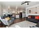 Open-concept living room with hardwood floors flowing into the kitchen and dining area at 13472 W Dakota Ave, Lakewood, CO 80228