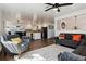 Open-concept living room with hardwood floors flowing into the kitchen and dining area at 13472 W Dakota Ave, Lakewood, CO 80228