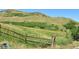 Natural landscape view with a wooden fence that adds character and defines the space at 13472 W Dakota Ave, Lakewood, CO 80228