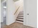 Stairway with carpet, painted risers and a wooden handrail at 13472 W Dakota Ave, Lakewood, CO 80228