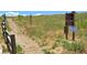 Picturesque walking path with wooden fence on the side and signage posted at 13472 W Dakota Ave, Lakewood, CO 80228