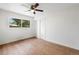 Bright bedroom featuring a ceiling fan, wood floors, and large window with natural light at 9320 Fir Dr, Thornton, CO 80229