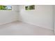 Cozy bedroom featuring plush carpet, neutral walls, and windows for abundant light at 9320 Fir Dr, Thornton, CO 80229