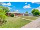 Single-story red brick home with well-kept lawn and a detached garage at 9320 Fir Dr, Thornton, CO 80229