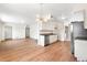 Updated kitchen featuring granite counters, new stainless steel appliances, and wood floors at 9320 Fir Dr, Thornton, CO 80229