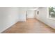 Bright living room with new wood floors, fresh white paint, and a view of the front yard at 9320 Fir Dr, Thornton, CO 80229