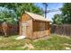 Backyard shed with ample storage space, built from plywood with a wooden door at 9320 Fir Dr, Thornton, CO 80229
