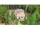Aerial view of a quaint house nestled among lush green trees at 9092 Gray Ln, Conifer, CO 80433