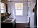 Bathroom with double sink vanity and subway tile tub surround at 9092 Gray Ln, Conifer, CO 80433