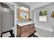Modern bathroom with dual sink vanity, wood-framed mirror, and subway tile at 9092 Gray Ln, Conifer, CO 80433