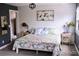 Bright bedroom with floral bedding, minimalist decor, and natural light at 9092 Gray Ln, Conifer, CO 80433