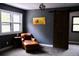 Cozy bedroom featuring a modern light fixture, accent chair, gray walls and a sliding barn door at 9092 Gray Ln, Conifer, CO 80433