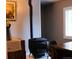 Dining area featuring a rustic wood burning stove and an antique cabinet at 9092 Gray Ln, Conifer, CO 80433