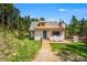 Charming home with a well-manicured lawn and a welcoming front porch at 9092 Gray Ln, Conifer, CO 80433