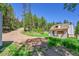 Charming home nestled in a wooded area, featuring a cozy front porch with seating at 9092 Gray Ln, Conifer, CO 80433