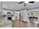 Bright kitchen featuring white cabinets, stainless steel appliances, and an adjacent laundry area at 9092 Gray Ln, Conifer, CO 80433