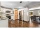 Well lit kitchen with stainless steel appliances and white cabinets, complete with hardwood flooring at 9092 Gray Ln, Conifer, CO 80433