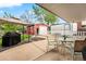 Enjoy outdoor living with a covered patio, a well-kept lawn, and mature landscaping at 2210 Miller St, Lakewood, CO 80215