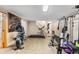 Basement gym area with exercise equipment and access to the laundry room at 2210 Miller St, Lakewood, CO 80215