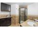 Bathroom featuring granite counters, cabinet storage, and a walk-in shower at 2210 Miller St, Lakewood, CO 80215