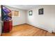 Bedroom featuring hardwood floors, a large window, and neutral walls at 2210 Miller St, Lakewood, CO 80215