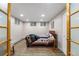 This bedroom offers hardwood-style flooring, recessed lighting, and an egress window at 2210 Miller St, Lakewood, CO 80215