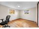 Bedroom featuring hardwood floors, lots of natural light and an office chair at 2210 Miller St, Lakewood, CO 80215