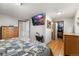 Bedroom featuring hardwood floors, a large mounted television and closet at 2210 Miller St, Lakewood, CO 80215