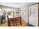 Dining area with natural light, hardwood floors, and a door to the exterior at 2210 Miller St, Lakewood, CO 80215