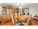 Formal dining room featuring hardwood floors, a china cabinet, and a view into the living room at 2210 Miller St, Lakewood, CO 80215