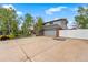 Charming two-story home with mature trees, an attached two-car garage and additional driveway parking at 2210 Miller St, Lakewood, CO 80215