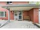 Charming covered front porch featuring a cozy bench, decorative door, and a well-maintained entryway at 2210 Miller St, Lakewood, CO 80215