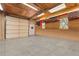 Spacious garage featuring red cabinets, windows, and a door at 2210 Miller St, Lakewood, CO 80215