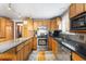 Updated kitchen featuring stainless steel appliances, granite countertops, and wood cabinets at 2210 Miller St, Lakewood, CO 80215