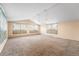 Spacious living room featuring large windows, neutral walls, and carpet floors at 2210 Miller St, Lakewood, CO 80215