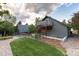 Exterior view of the home showcasing the deck, garden area, and landscaping in the backyard at 1392 W Caley Ave, Littleton, CO 80120