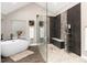 A modern bathroom features a soaking tub, large glass shower, and neutral colored walls at 1392 W Caley Ave, Littleton, CO 80120