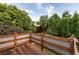 Inviting wooden deck overlooking a beautiful backyard full of mature trees and green foliage at 1392 W Caley Ave, Littleton, CO 80120