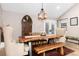 Dining room with a wooden table, two upholstered chairs and a wooden bench with natural light at 1392 W Caley Ave, Littleton, CO 80120