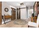 Beautiful foyer featuring wood floors, a wooden barn-door, and stylish decor at 1392 W Caley Ave, Littleton, CO 80120