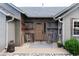 Inviting front entrance featuring a wooden facade, covered porch and professionally landscaped yard at 1392 W Caley Ave, Littleton, CO 80120