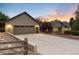 Large detached two-car garage with ample parking and a professionally landscaped entrance at 1392 W Caley Ave, Littleton, CO 80120