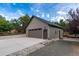 Large detached two-car garage with ample parking and a professionally landscaped entrance at 1392 W Caley Ave, Littleton, CO 80120