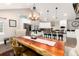 Spacious kitchen with white cabinetry, stainless steel appliances, and a breakfast bar next to the dining area at 1392 W Caley Ave, Littleton, CO 80120