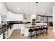 Bright kitchen with a granite island, stainless steel appliances, breakfast bar, and hardwood flooring at 1392 W Caley Ave, Littleton, CO 80120