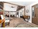 Spacious open-concept living room featuring wood beam accents, hardwood floors, and neutral decor at 1392 W Caley Ave, Littleton, CO 80120