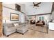 Spacious open-concept living room featuring wood beam accents, hardwood floors, and neutral decor at 1392 W Caley Ave, Littleton, CO 80120